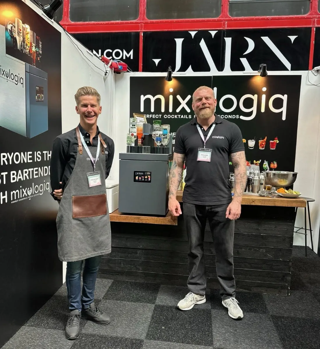 Två värdar framför Mixologiq-montern